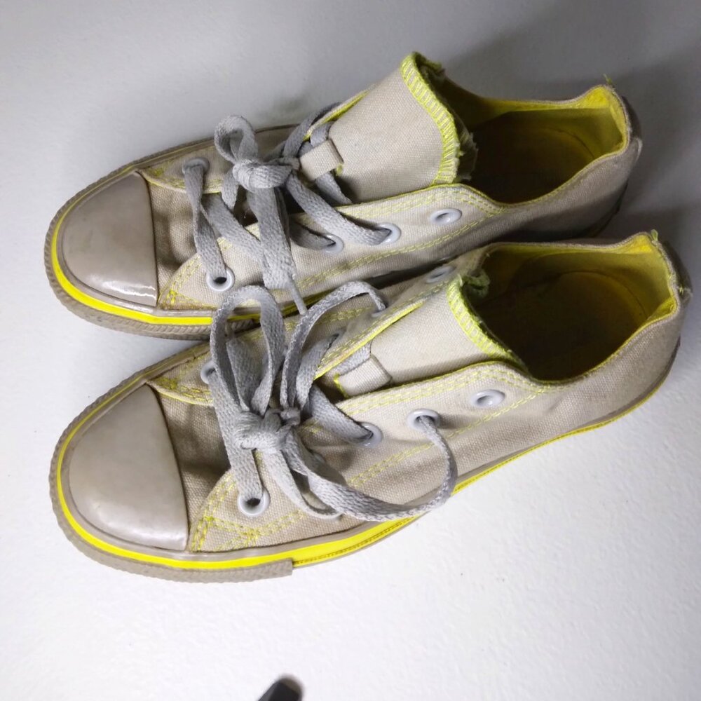 the iconic Converse Chuck Taylor All Star Ox sneakers. (Gray and Yellow.)